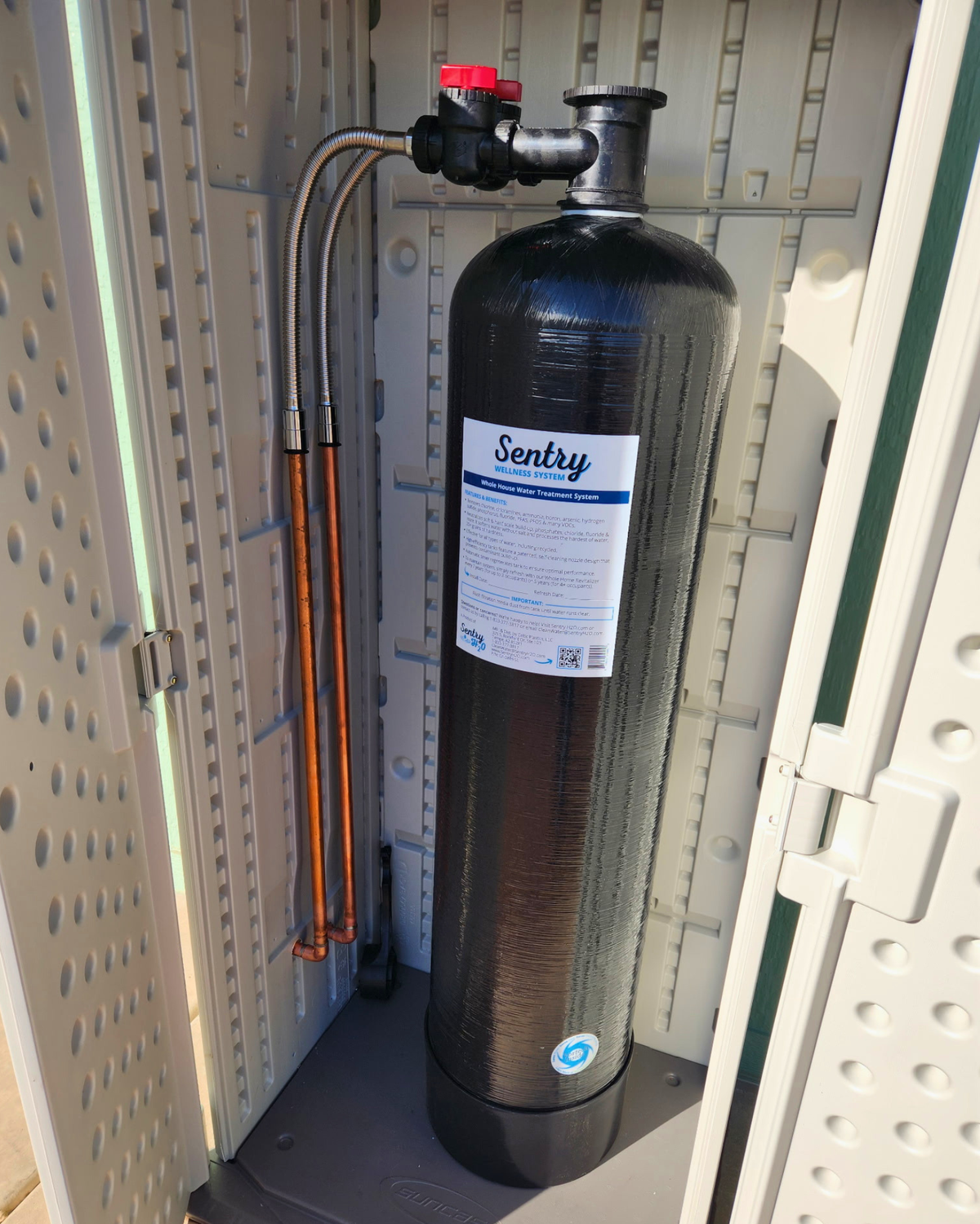 Sentry H2O whole house filter tank installed in a utility room