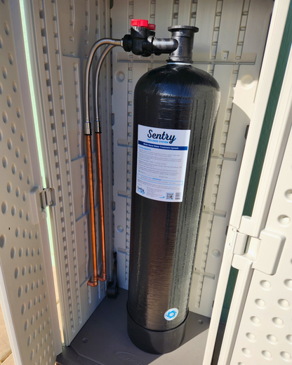 Sentry H2O whole house filter tank installed in a utility room