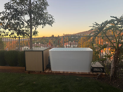 RevX Acrylic X Tub cold plunge in a backyard at sunset
