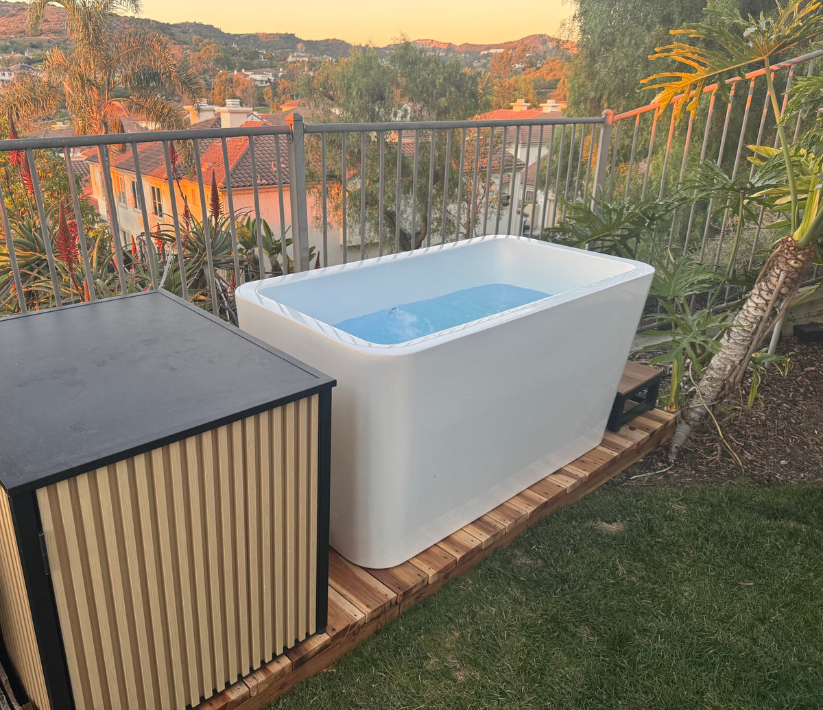 RevX Acrylic X Tub cold plunge filled with water on a garden deck