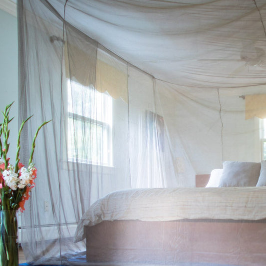 SYB Faraday bed canopy over a bed in a bright bedroom