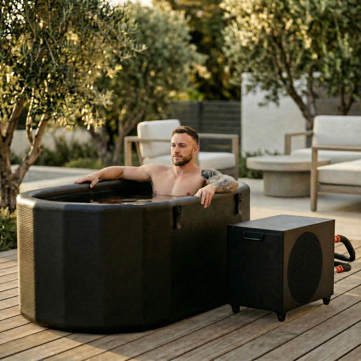 Man relaxing in the Nicebeam Cryo Pro XXL inflatable cold plunge on a patio
