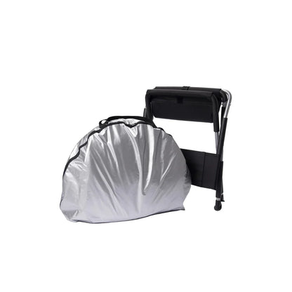 Relax Silver Elite tent sauna folded in its carry bag beside the folding chair